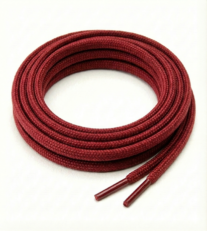 Red shoelaces coiled on a white background Color: Red