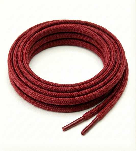 Red shoelaces coiled on a white background Color: Red